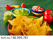 Mexican food nachos guacamole pico de gallo and chili peppers sauces. Стоковое фото, агентство Ingram Publishing / Фотобанк Лори