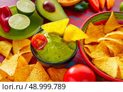 Mexican food nachos and guacamole with chili peppers and sauces. Стоковое фото, агентство Ingram Publishing / Фотобанк Лори