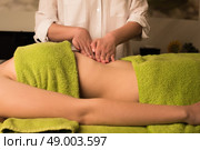 Young woman having a waist massage at the spa. Стоковое фото, агентство Ingram Publishing / Фотобанк Лори