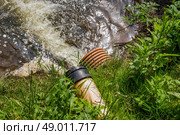 Pipe with spill water at a lake. Стоковое фото, агентство Ingram Publishing / Фотобанк Лори