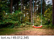 Childrens playground swing in the middle of the forest. Стоковое фото, агентство Ingram Publishing / Фотобанк Лори
