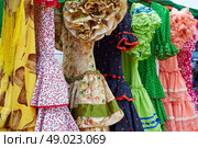 Andalusian gipsy dresses in a row at Spain outdoor market. Стоковое фото, агентство Ingram Publishing / Фотобанк Лори