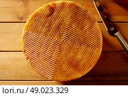 Manchego cheese from Spain in wooden table texture detail. Стоковое фото, агентство Ingram Publishing / Фотобанк Лори