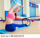 Pilates woman side stretch magic ring exercise workout at gym indoor. Стоковое фото, агентство Ingram Publishing / Фотобанк Лори
