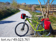 cycling tourism MTB bike in Ribarroja Parc de Turia with paniers and saddlebag. Стоковое фото, агентство Ingram Publishing / Фотобанк Лори