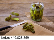 bottled pickles cucumbers in vintage wooden table. Стоковое фото, агентство Ingram Publishing / Фотобанк Лори