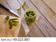 bottled pickles cucumbers in vintage wooden table. Стоковое фото, агентство Ingram Publishing / Фотобанк Лори