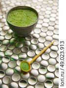 Matcha green tea from Japan on modern stainless steel background. Стоковое фото, агентство Ingram Publishing / Фотобанк Лори
