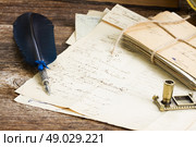feather pen .  pile of  old letters and blue  feather pen. Стоковое фото, агентство Ingram Publishing / Фотобанк Лори