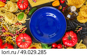 Raw pasta with ingridients and copy space on empty blue plate. Raw pasta with ingridients and blue plate. Стоковое фото, агентство Ingram Publishing / Фотобанк Лори