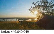 A man takes off his glasses, in awe of the beautiful summer sunset view of nature. Close up. Стоковое видео, видеограф Strunov David / Фотобанк Лори