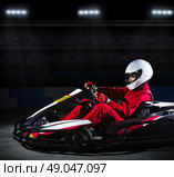 Young girl karting racer at stadium. Стоковое фото, агентство Ingram Publishing / Фотобанк Лори