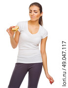 Doubting young woman with sandwich isolated. Стоковое фото, агентство Ingram Publishing / Фотобанк Лори