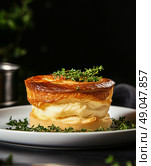 Delicious Souffl Served on a Plate Garnished With Fresh Thyme in a Dark Setting. Стоковое AI-изображение, AI-художник Юлия Гапеенко / Фотобанк Лори