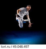 Breakdancer training on dark background. Стоковое фото, агентство Ingram Publishing / Фотобанк Лори