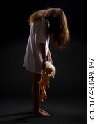 Zombie girl with doll on black. Стоковое фото, агентство Ingram Publishing / Фотобанк Лори
