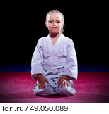 Little girl aikido fighter on black. Стоковое фото, агентство Ingram Publishing / Фотобанк Лори
