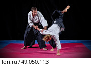Fight between two aikido fighters on black. Стоковое фото, агентство Ingram Publishing / Фотобанк Лори