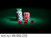Gambling chips and dices on green table. Стоковое фото, агентство Ingram Publishing / Фотобанк Лори