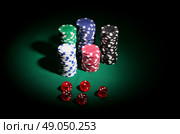 Gambling chips and dices on green table. Стоковое фото, агентство Ingram Publishing / Фотобанк Лори