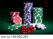 Gambling chips and dices on green table. Стоковое фото, агентство Ingram Publishing / Фотобанк Лори