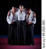 Three aikido fighters on black. Стоковое фото, агентство Ingram Publishing / Фотобанк Лори