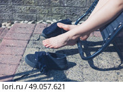 The legs and feet of a woman outside as she is relaxing on a sun lounger. Стоковое фото, агентство Ingram Publishing / Фотобанк Лори