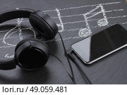 Music notes with treble clef, smartphone  and headphones. Стоковое фото, агентство Ingram Publishing / Фотобанк Лори