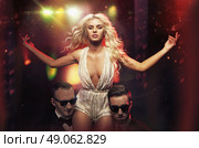 Stunning star protected by the handsome bodyguards. Стоковое фото, агентство Ingram Publishing / Фотобанк Лори