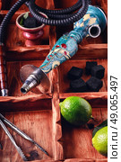Accessories for Shisha. dismantled parts of the hookah in stylish wooden box with fruits lime. Стоковое фото, агентство Ingram Publishing / Фотобанк Лори