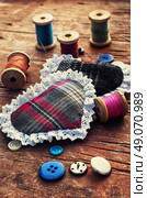 Accessories for home crafts.  button and spools of thread for needlework on bright background. Стоковое фото, агентство Ingram Publishing / Фотобанк Лори