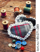 Accessories for home crafts.  button and spools of thread for needlework on bright background. Стоковое фото, агентство Ingram Publishing / Фотобанк Лори