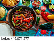 Beef fajitas in a pan with sauces chili and sides Mexican food. Стоковое фото, агентство Ingram Publishing / Фотобанк Лори
