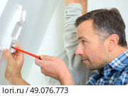 Repairing an intercom receiver. Стоковое фото, агентство Ingram Publishing / Фотобанк Лори