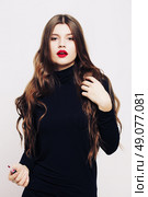 Beautiful girl with long wavy healthy hair. Brunette with curly hairstyle, and professional makeup, red lips. Стоковое фото, агентство Ingram Publishing / Фотобанк Лори