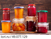 various jars of fruit jam on wooden background. Стоковое фото, агентство Ingram Publishing / Фотобанк Лори
