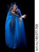 Elven conjures girl isolated on black. Стоковое фото, агентство Ingram Publishing / Фотобанк Лори