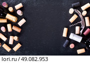 wine corks, corkscrew and bottle of wine on dark background. Стоковое фото, агентство Ingram Publishing / Фотобанк Лори