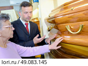 Elderly lady choosing coffin. Стоковое фото, агентство Ingram Publishing / Фотобанк Лори