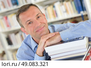 on a pile of books. Стоковое фото, агентство Ingram Publishing / Фотобанк Лори
