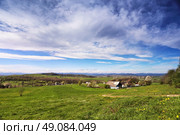 Spring green hills blooming. Valley behind the foothills in Ukraine. Стоковое фото, агентство Ingram Publishing / Фотобанк Лори