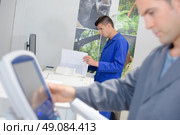 Man entering information on to control pad. Стоковое фото, агентство Ingram Publishing / Фотобанк Лори