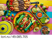Mexican chicken and beef fajitas tacos in colorful table with sauce. Стоковое фото, агентство Ingram Publishing / Фотобанк Лори