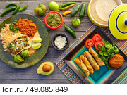 Mexican carnitas tacos with flautas from Mexico food ingredients. Стоковое фото, агентство Ingram Publishing / Фотобанк Лори
