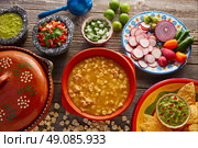 Green Pozole verde with blanco mote corn and ingredients on wooden table. Стоковое фото, агентство Ingram Publishing / Фотобанк Лори
