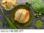 Mexican Tamale tamales of corn leaves with chili and sauces. Стоковое фото, агентство Ingram Publishing / Фотобанк Лори