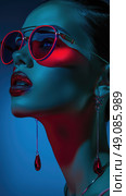 Close-up portrait of a woman wearing red sunglasses and teardrop earrings, with blue and red lighting. Стоковое AI-изображение, AI-художник Данила Большаков / Фотобанк Лори