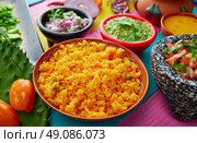 Mexican yellow rice with chilis and sauces in colorful background. Стоковое фото, агентство Ingram Publishing / Фотобанк Лори