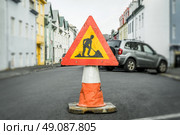 Roadwork sign on a cone at a street. Стоковое фото, агентство Ingram Publishing / Фотобанк Лори