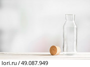 Glass bottle with a brown cork on a wooden table. Стоковое фото, агентство Ingram Publishing / Фотобанк Лори